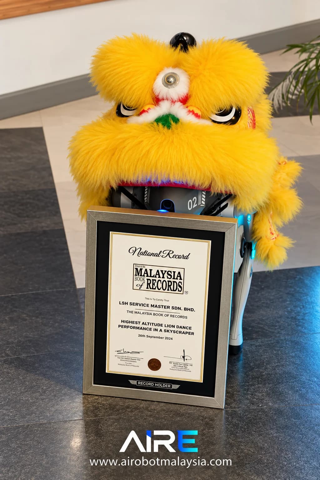 Yellow lion-dance head displayed above a framed certificate